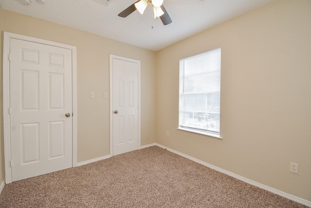 unfurnished bedroom featuring ceiling fan and carpet flooring