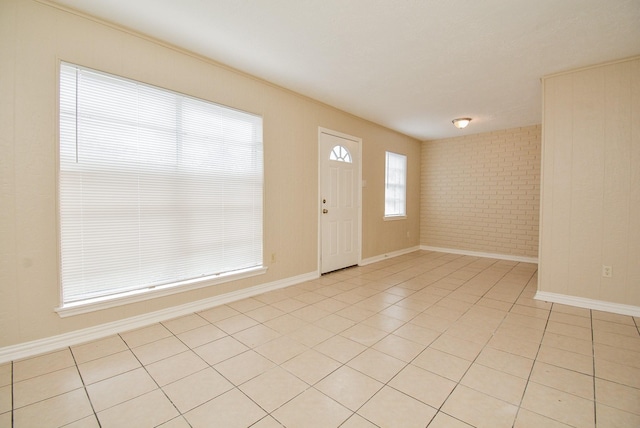 tiled entryway with brick wall