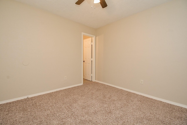 carpeted spare room with ceiling fan and a textured ceiling