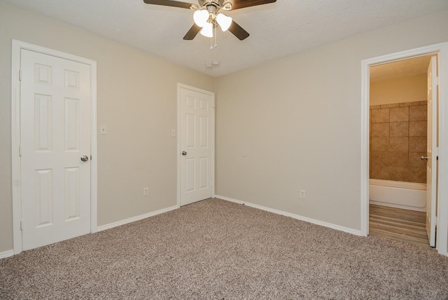 unfurnished bedroom with carpet floors, connected bathroom, and ceiling fan