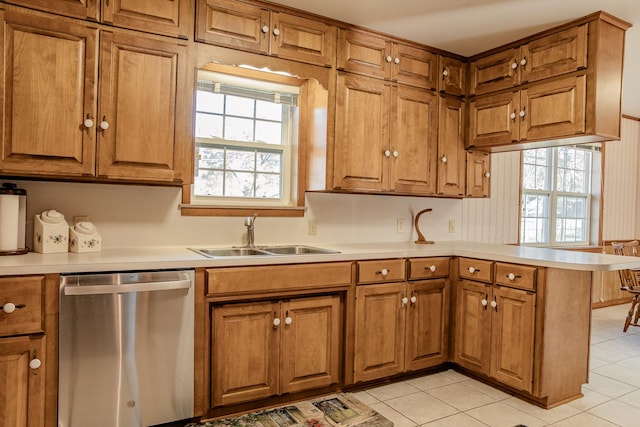 kitchen featuring sink, light tile patterned floors, kitchen peninsula, and dishwasher