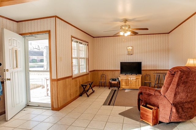 tiled living room featuring ceiling fan and ornamental molding