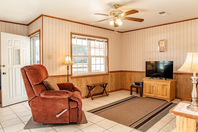 tiled living room with crown molding and ceiling fan