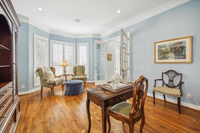 sitting room featuring ornamental molding and light hardwood / wood-style floors