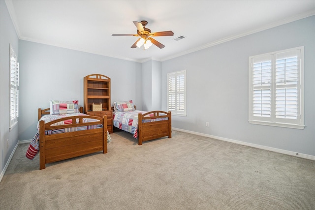 carpeted bedroom featuring crown molding and ceiling fan