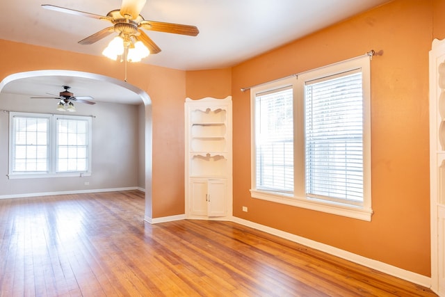 empty room featuring hardwood / wood-style flooring, plenty of natural light, and ceiling fan