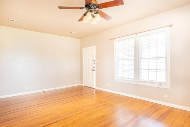 spare room featuring hardwood / wood-style floors and ceiling fan