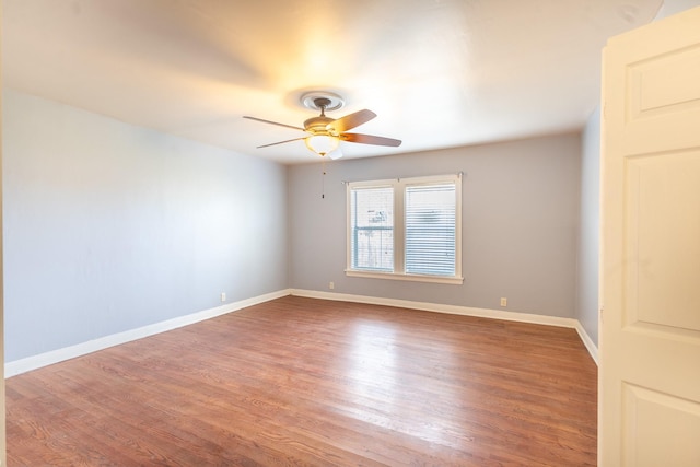 empty room with hardwood / wood-style flooring and ceiling fan