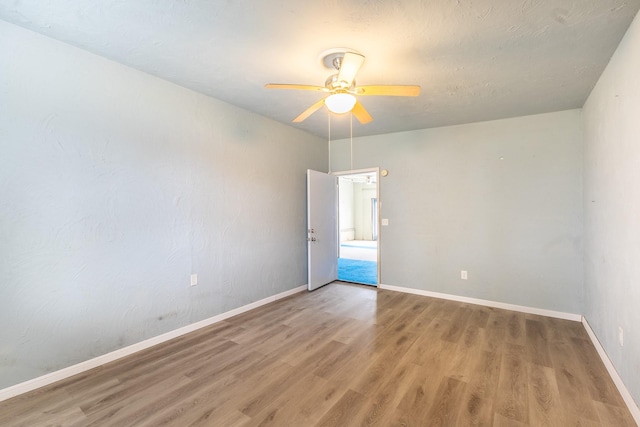 empty room featuring ceiling fan and wood-type flooring