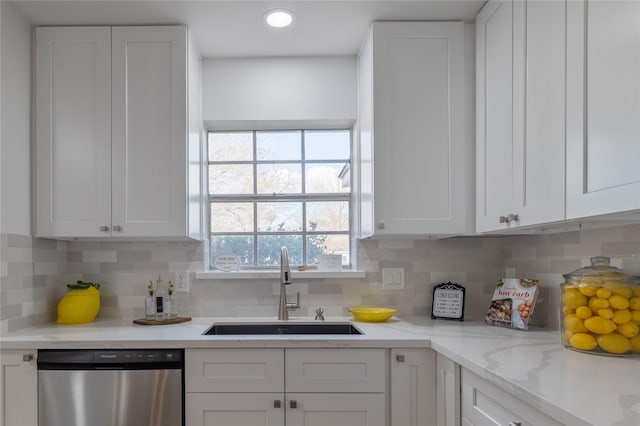 kitchen with white cabinetry, sink, and stainless steel dishwasher