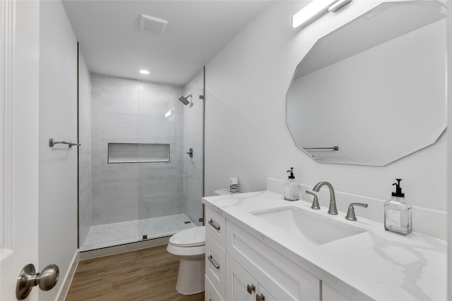 bathroom featuring vanity, toilet, an enclosed shower, and hardwood / wood-style floors