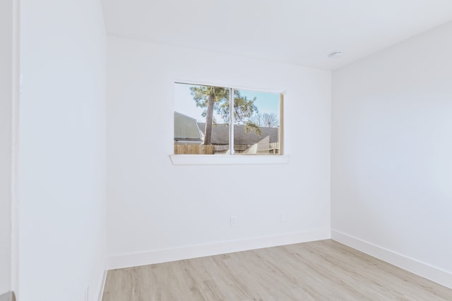 empty room with light hardwood / wood-style flooring