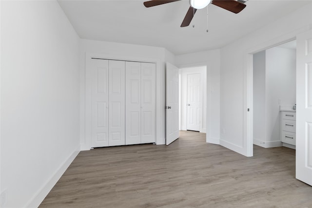 unfurnished bedroom with ceiling fan, a closet, and light hardwood / wood-style flooring