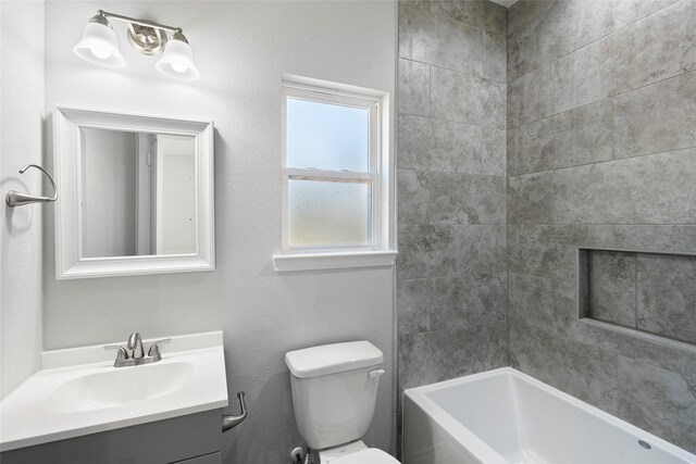 full bathroom featuring vanity, toilet, and tiled shower / bath combo