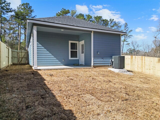 rear view of property featuring central AC and a patio area