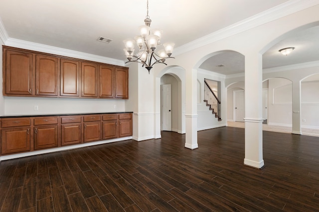 kitchen featuring crown molding, dark hardwood / wood-style flooring, a chandelier, and hanging light fixtures