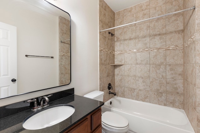 full bathroom with vanity, toilet, and tiled shower / bath combo