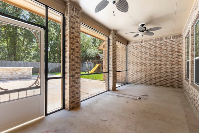 unfurnished sunroom with ceiling fan