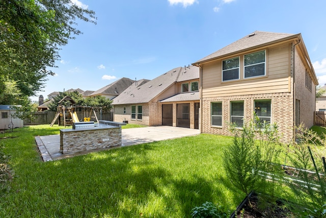 back of property featuring a yard, a patio, and a playground