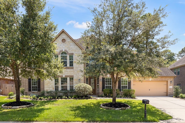 view of front of property featuring a garage and a front lawn