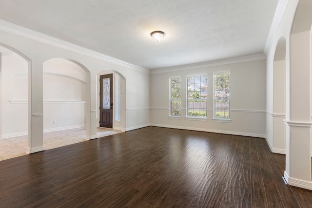 spare room featuring hardwood / wood-style flooring and ornamental molding