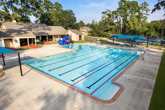 view of pool featuring a playground and a patio area