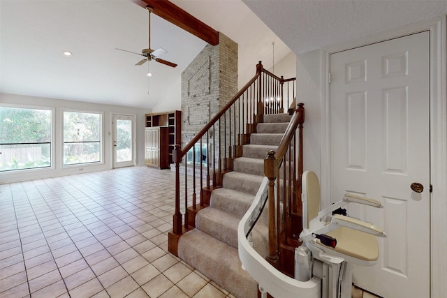 staircase featuring ceiling fan, high vaulted ceiling, a textured ceiling, tile patterned floors, and beamed ceiling