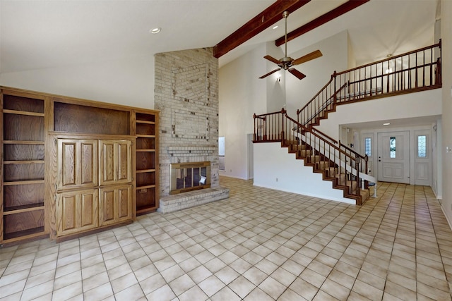 unfurnished living room featuring light tile patterned flooring, high vaulted ceiling, a fireplace, beamed ceiling, and ceiling fan