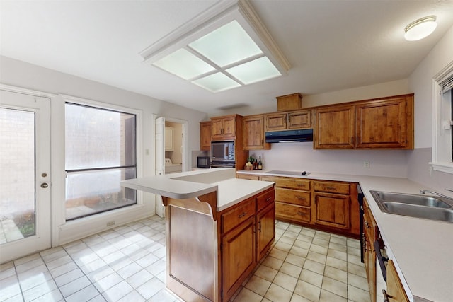 kitchen with sink, light tile patterned floors, a center island, black electric stovetop, and built in microwave