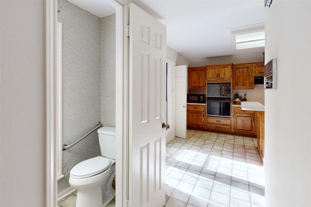 interior space featuring black appliances and light tile patterned flooring