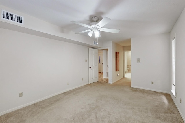 spare room featuring light carpet and ceiling fan