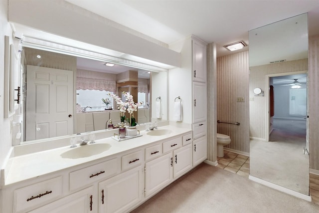 bathroom with vanity, toilet, and tile patterned flooring