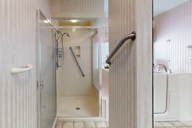 bathroom with walk in shower and tile patterned floors