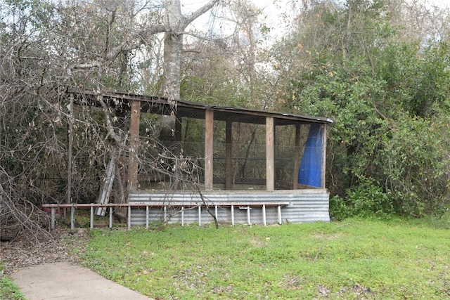 view of outbuilding with a lawn