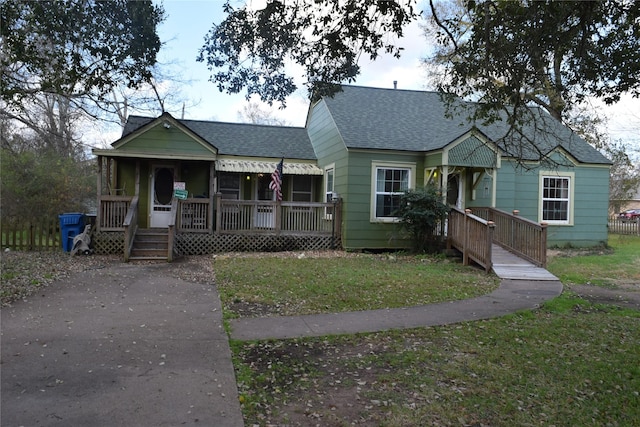 bungalow-style home with a front yard and a porch