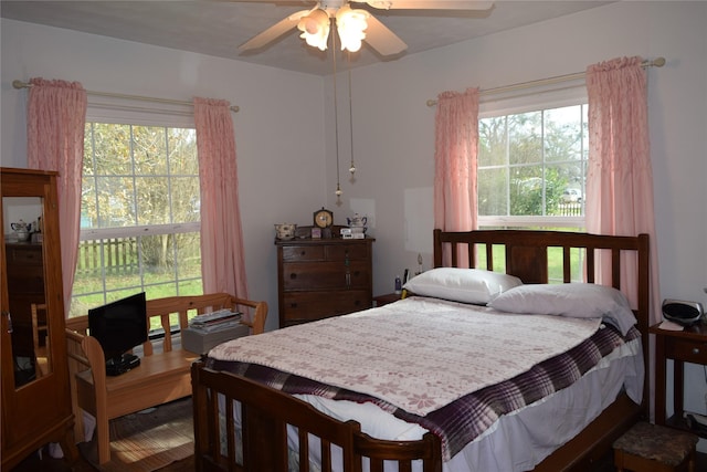 bedroom with ceiling fan and multiple windows