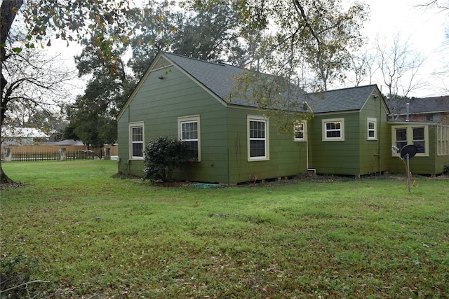 rear view of house with a lawn