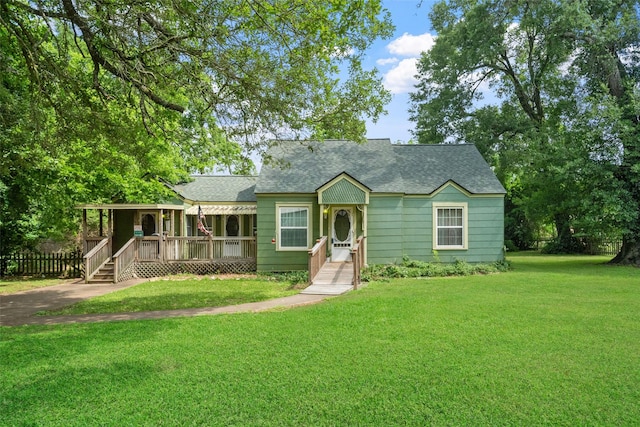 2506 Brazeal St, Waller, TX 77484 - view of front of property featuring covered porch, roof with shingles, a front lawn, and fence