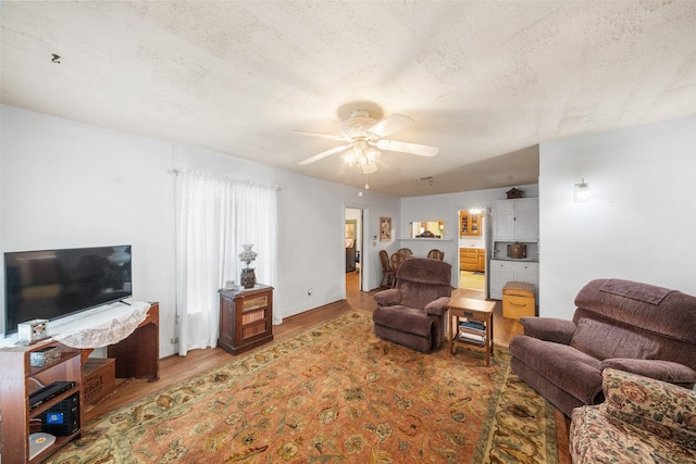 2506 Brazeal St, Waller, TX 77484 - living area featuring ceiling fan, a textured ceiling, and wood finished floors