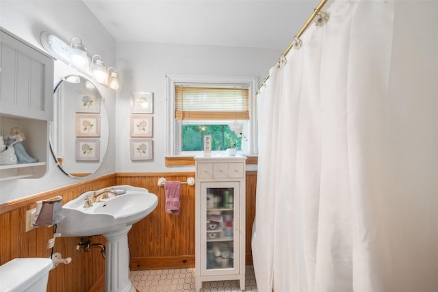 2506 Brazeal St, Waller, TX 77484 - bathroom with tile patterned floors, toilet, wooden walls, and wainscoting