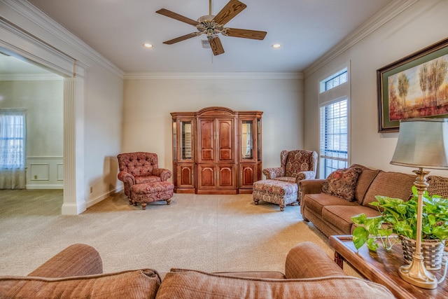 living room with ceiling fan, ornamental molding, and carpet