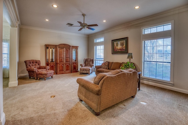 carpeted living room featuring crown molding, decorative columns, and ceiling fan