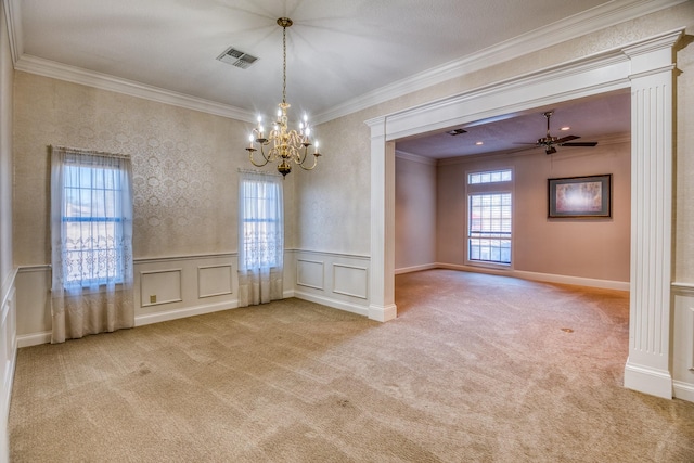 unfurnished dining area featuring light carpet, crown molding, ceiling fan with notable chandelier, and decorative columns