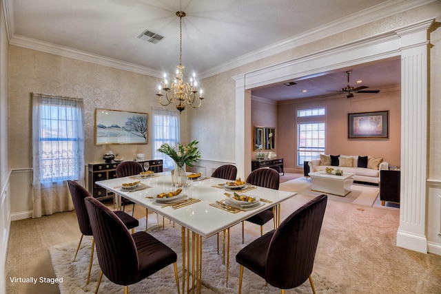 carpeted dining area with ornamental molding and ceiling fan with notable chandelier