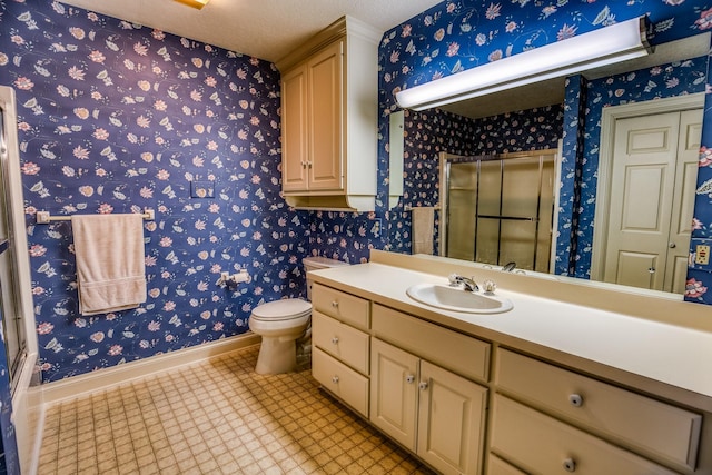 bathroom with vanity, a textured ceiling, and toilet