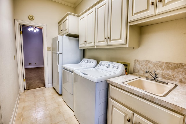 washroom with cabinets, sink, and washer and clothes dryer