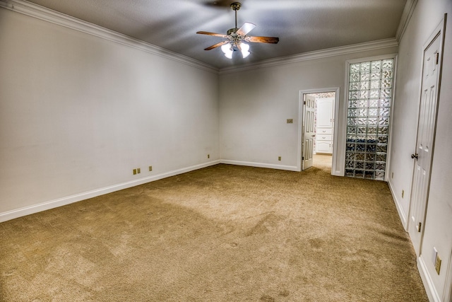 carpeted empty room featuring a textured ceiling, ornamental molding, and ceiling fan