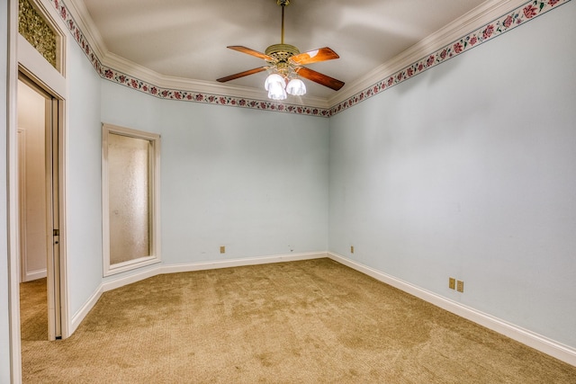 carpeted empty room with ornamental molding and ceiling fan