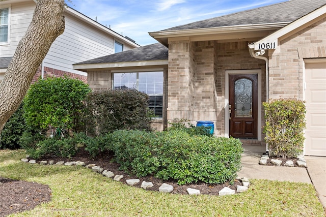 doorway to property with a lawn