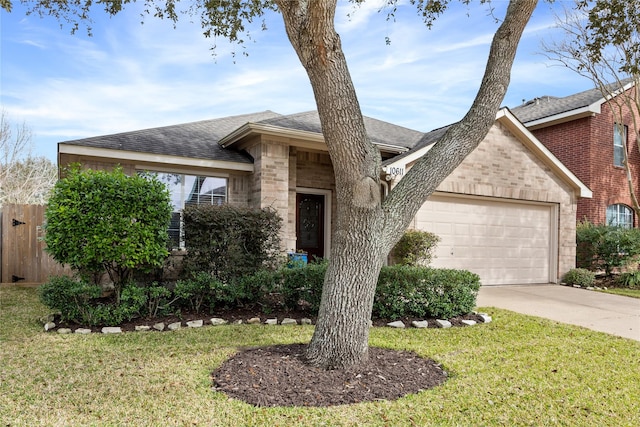 ranch-style home featuring a garage and a front yard